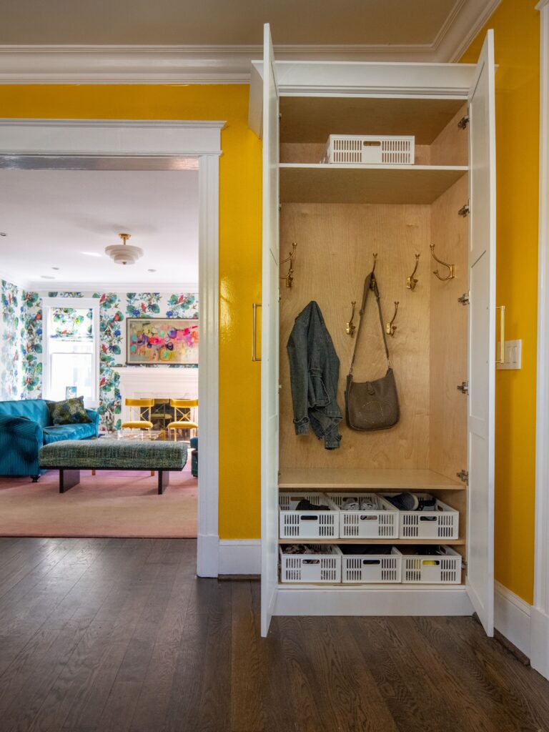 Organized guest room closet with neat storage solutions for luggage and clothes.