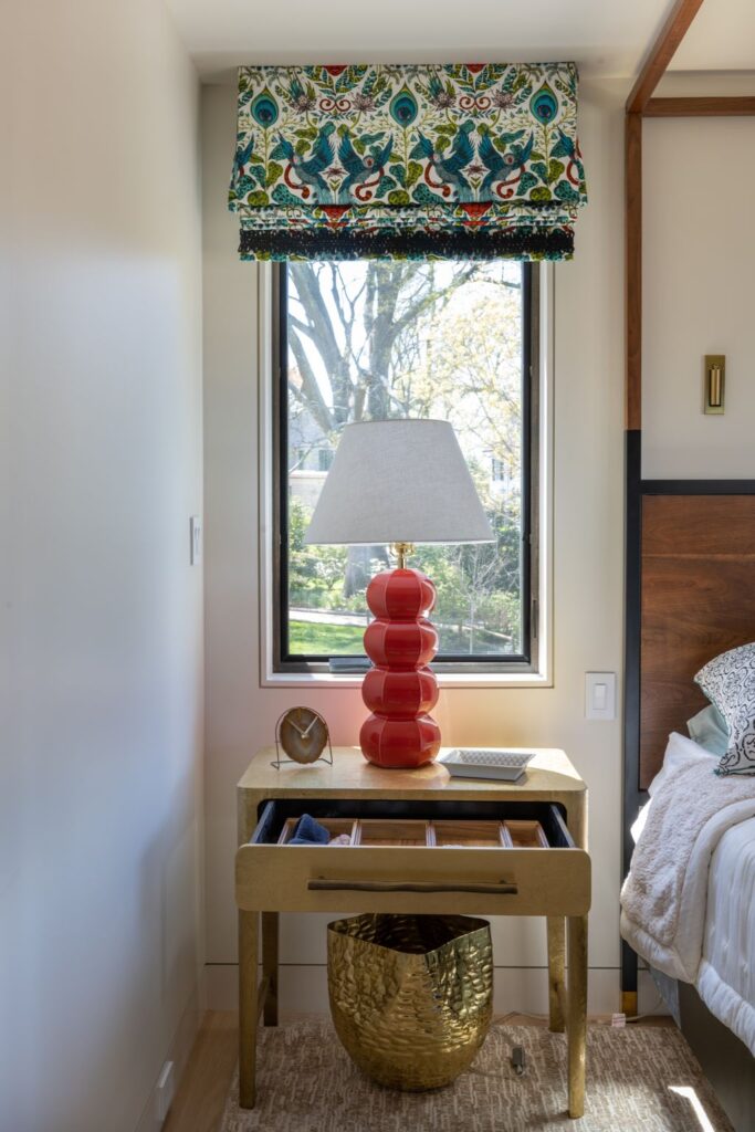 Holiday-themed guest room with festive décor, including a vase of seasonal flowers and cozy accessories.